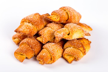 pile of fresh and delicious croissants on a white background