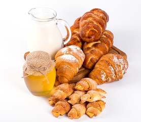 pile of fresh and delicious croissants on a white background