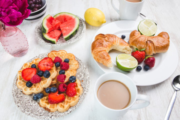 Schön gedeckter Tisch mit frischen Waffeln und Kaffee