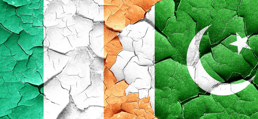 Ireland flag with Pakistan flag on a grunge cracked wall