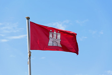 Flag of the City of Hamburg, Germany, fluttering in the wind, blue sky