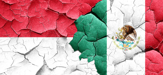 Indonesia flag with Mexico flag on a grunge cracked wall