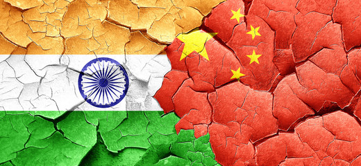 India flag with China flag on a grunge cracked wall