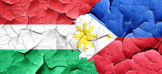 Hungary flag with Philippines flag on a grunge cracked wall