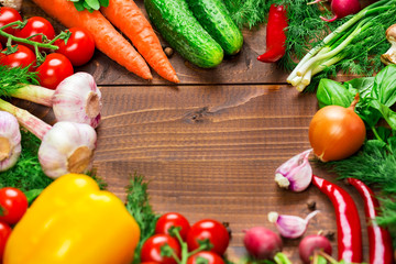 Beautiful background healthy organic eating. Studio photography the frame of different vegetables and mushrooms on the old brown boards with free space