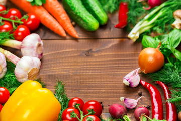 Beautiful background healthy organic eating. Studio photography the frame of different vegetables and mushrooms on the old brown boards with free space