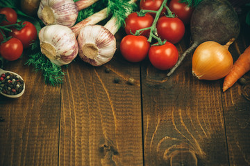 Beautiful background healthy organic eating. Studio photography the frame of different vegetables and mushrooms on the old brown boards with free space