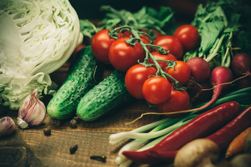Beautiful background healthy organic eating. Studio photography of different vegetables and mushrooms on the old brown boards
