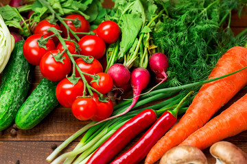 Beautiful background healthy organic eating. Studio photography of different vegetables and mushrooms on the old brown boards