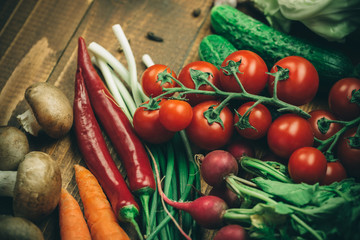 Beautiful background healthy organic eating. Studio photography of different vegetables and mushrooms on the old brown boards