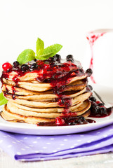 Stack of pancakes topped with berry jam