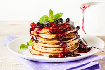 Stack of pancakes topped with berry jam