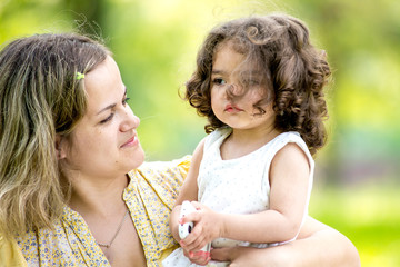 Fototapeta premium Happy mother and daughter with embracing, close up portrait.