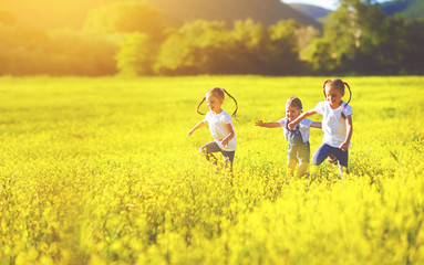 happy children friends sisters run and play outdoors