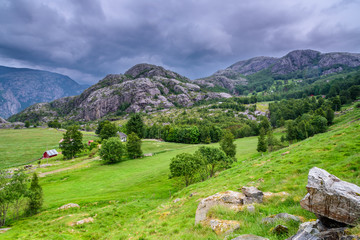 Fototapeta na wymiar Stormy clouds, hanging over a beautiful valley in Norway