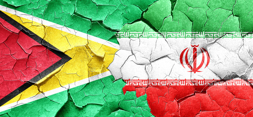Guyana flag with Iran flag on a grunge cracked wall