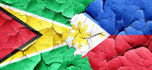 Guyana flag with Philippines flag on a grunge cracked wall