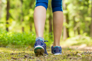 Walking or running legs in forest, exercising in summer nature.T