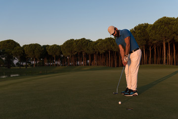 golfer  hitting shot at golf course