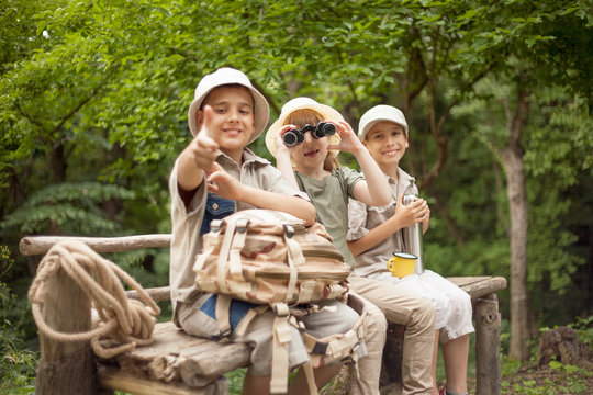 young girl explores the nature with binoculars