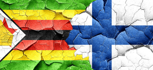 Zimbabwe flag with Finland flag on a grunge cracked wall