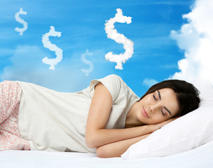 Beautiful girl lying on blue cloudy sky