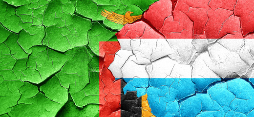 Zambia flag with Luxembourg flag on a grunge cracked wall