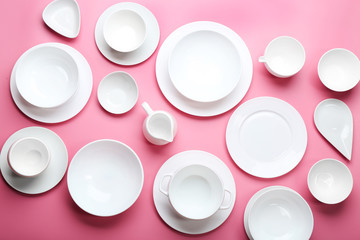 Set of white dishes on pink background