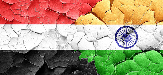 Yemen flag with India flag on a grunge cracked wall
