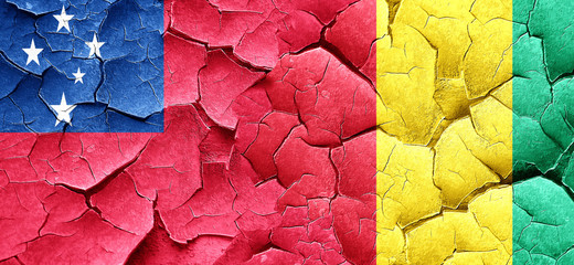 Samoa flag with Guinea flag on a grunge cracked wall