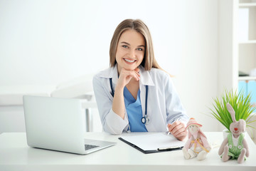 Young beautiful female doctor working at the office