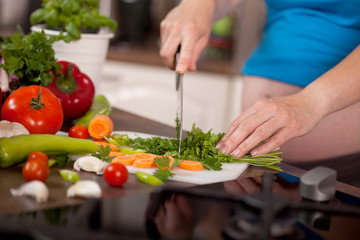 Pregnant woman preparing a healthy meal in the kitchen