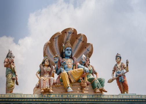 Chettinad, India - October 17, 2013: Shiva temple at Kottaiyur shows Lord Vishnu, Devi Lakshmi and Devi Bhu sitting on coils of five-headed cobra Shesha. Called Sheshanarayana. Hayagriva