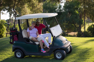couple in buggy on golf course