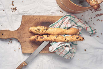 bread sticks on wooden cutting board - top view