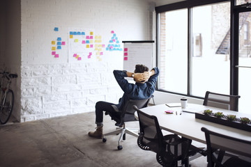 Man looking at adhesive note on wall