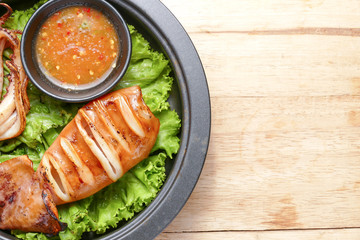 Grilled squid and vegetable with spicy seafood sauce on frying p