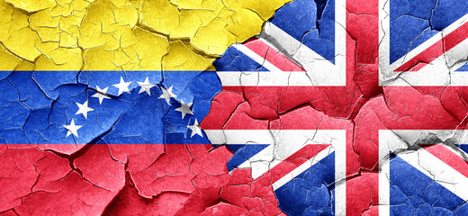 Venezuela flag with Great Britain flag on a grunge cracked wall