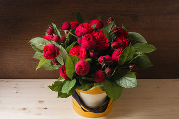 Rich bunch of pink eustoma and roses flowers, green leaf in hand Fresh spring bouquet. Summer Background. composition hatbox