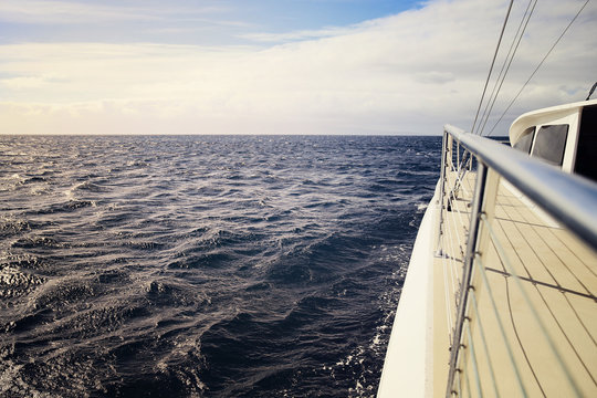 Cropped image of boat moving in sea against sky