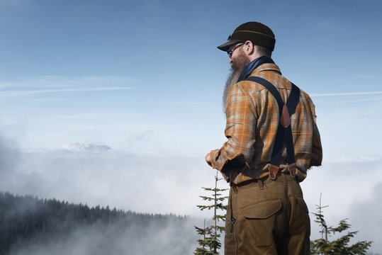 Rear View Of Man Standing Against Sky On Sunny Day