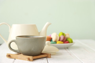 Stock Photo:.Cup of tea and gentle colorful macaroons in white b