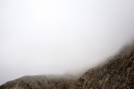 Scenic view of mountain against cloudy sky