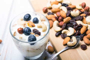 Healthy dessert with yogurt, nuts, oats and blueberries
