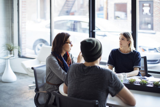 Serious Business People Discussing During Meeting In Office