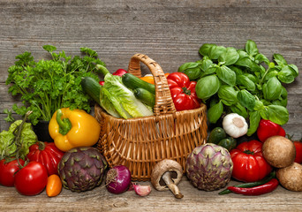 Vegetables and herbs on wooden background. Food ingredients