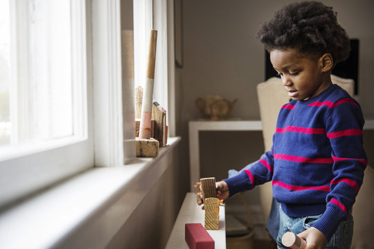 Boy Playing With Wooden Blocks At Home