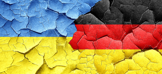 Ukraine flag with Germany flag on a grunge cracked wall