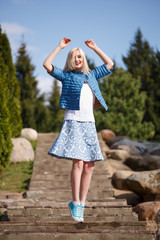 Portrait of beautiful girl posing in the Park fashion style skirt jacket