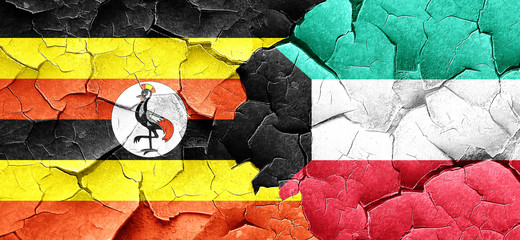 Uganda flag with Kuwait flag on a grunge cracked wall